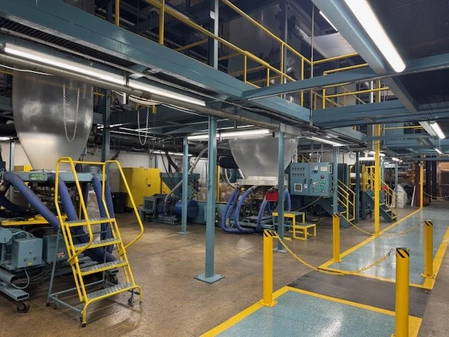 a large industrial plant with yellow pipes and machinery