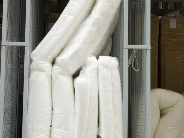a stack of white sheets in a storage