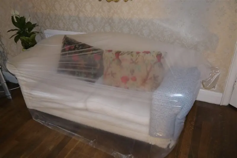 a couch wrapped in plastic