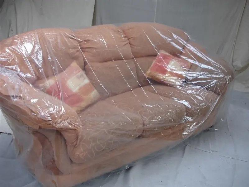 a couch wrapped in plastic