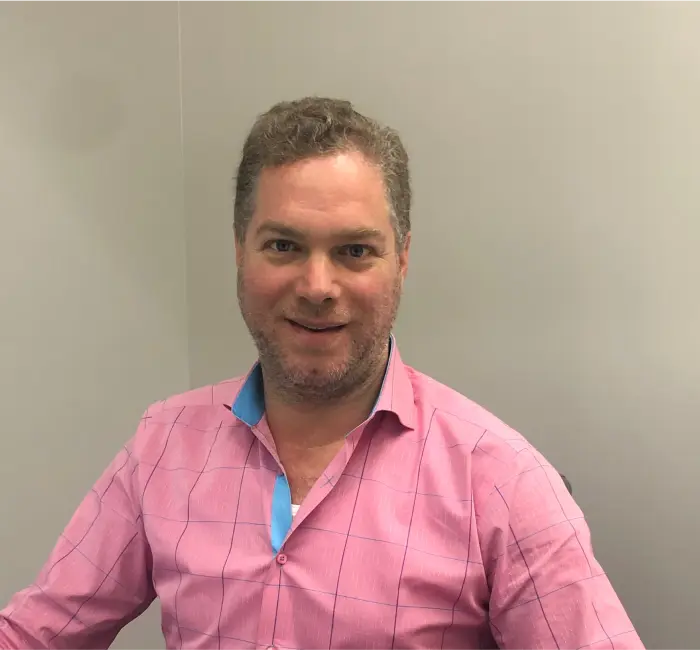 a man in a pink shirt
