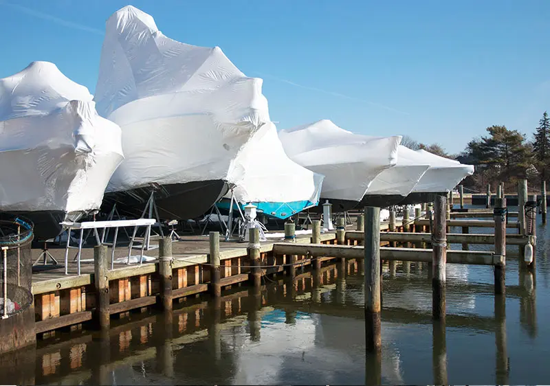 a group of boats covered in white cover