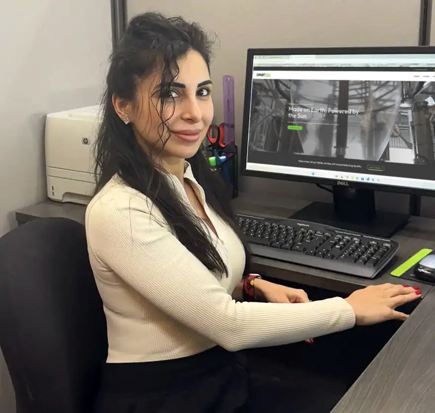 a woman sitting at a desk with a computer