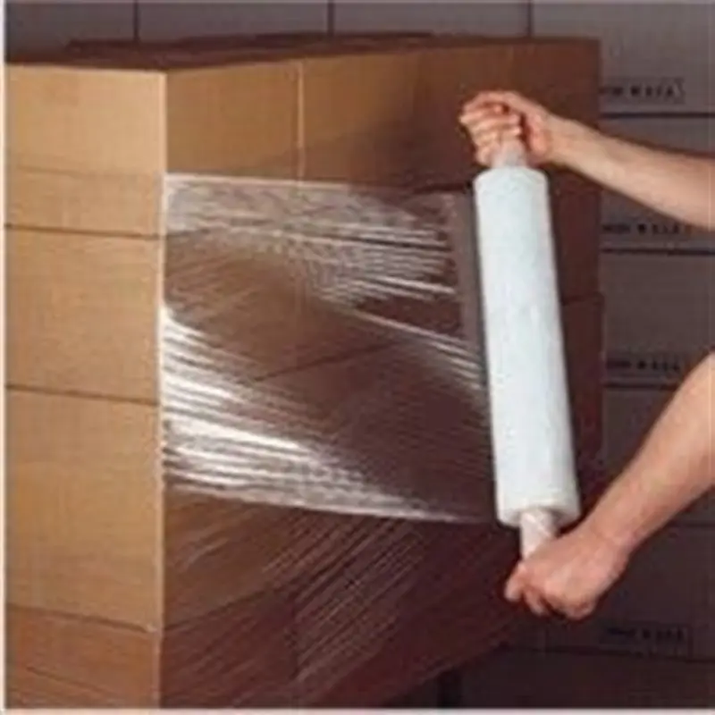 a hand holding a roll of plastic