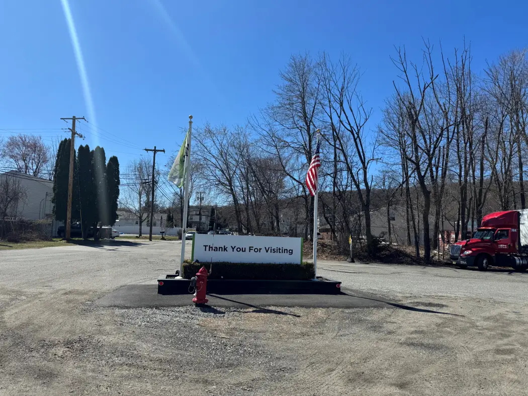 a sign in front of a parking lot