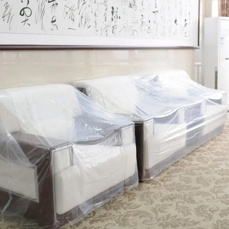 a couches wrapped in plastic